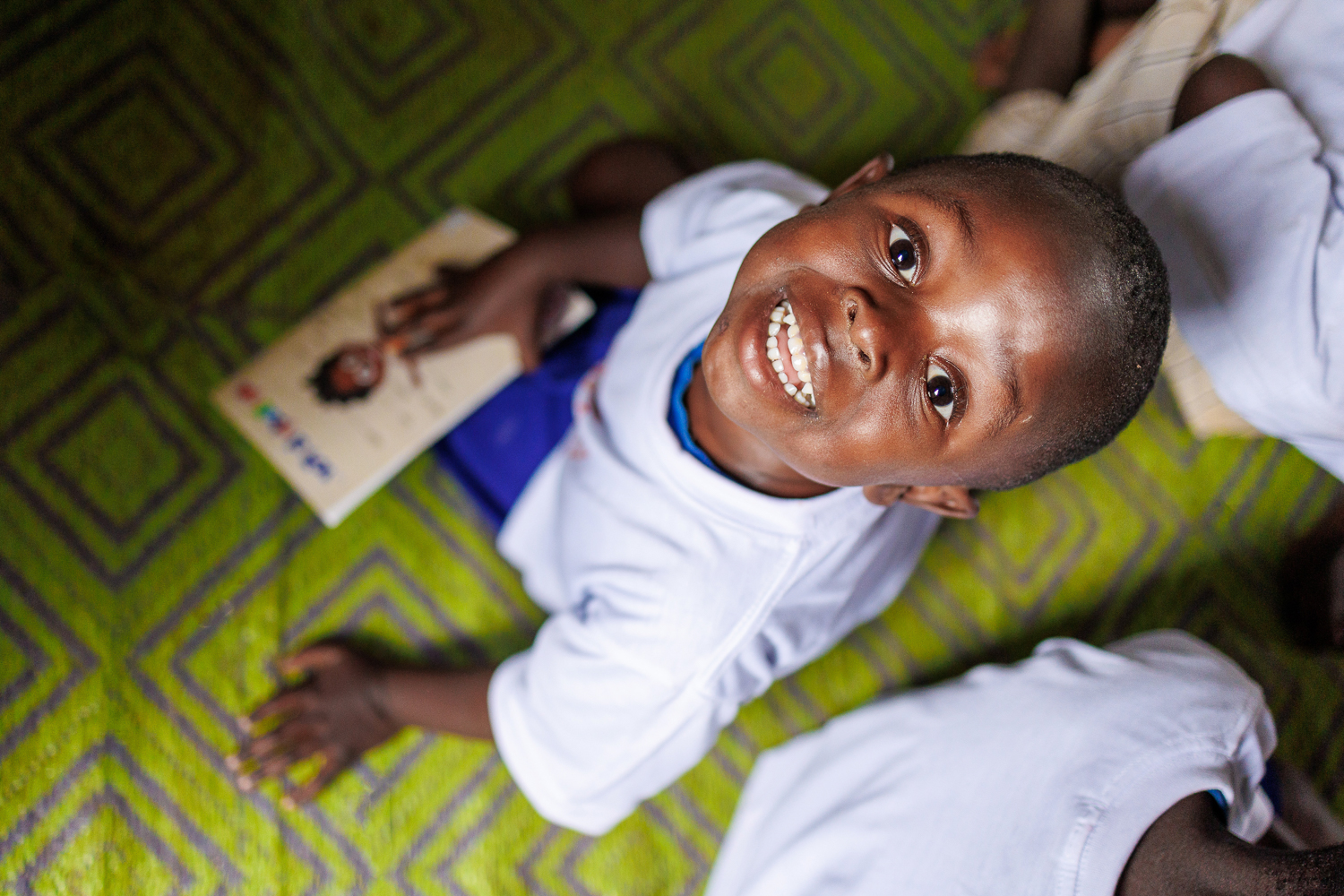 A caregiver engaging with a young child during a learning activity