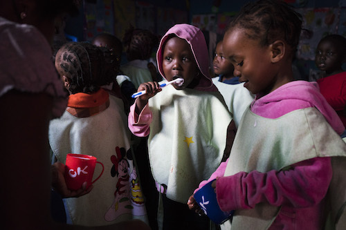Kenyan Children Brush Their Teeth At The Ecd Programme In Kibera