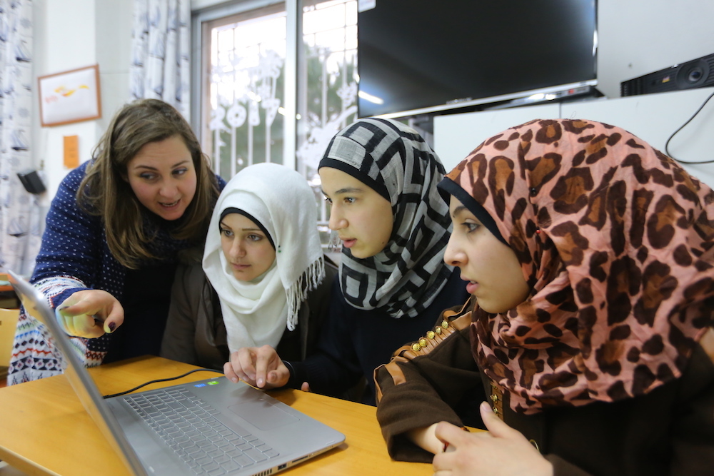 Tech Hub Teacher Carine Sobieh Shows Syrian Girls At Mtein School In Lebanon Hwo To Complete A Maths Exercise On The Computer