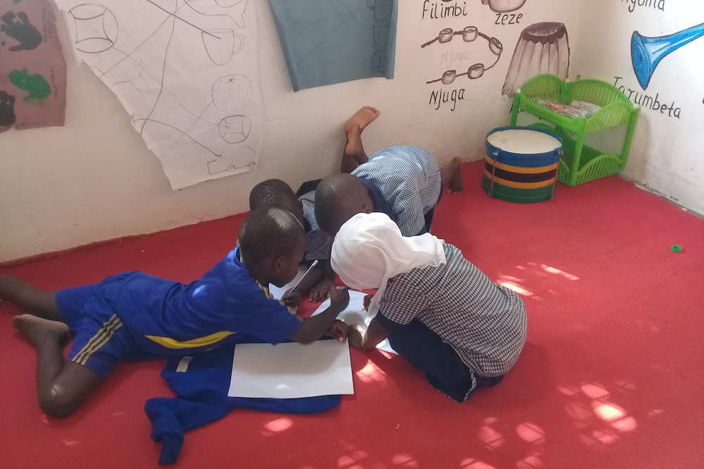 Children At Brac Play Lab In Machimbo Tanzania Playing A Drawing Game