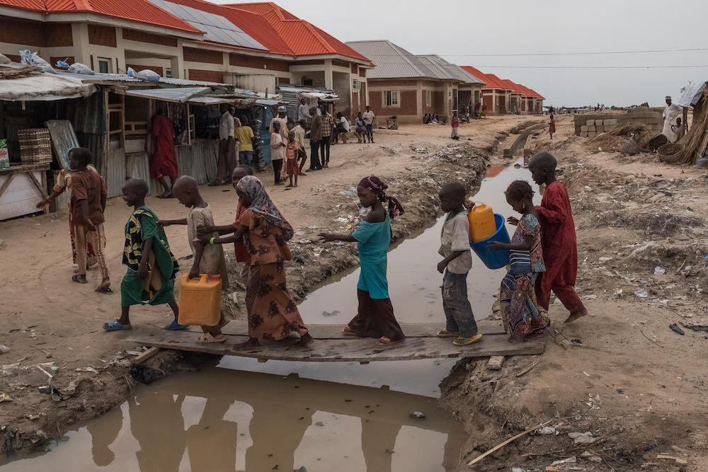 Nigerian Children Cross Ditch In Teachers Village Idp Campa In Borno