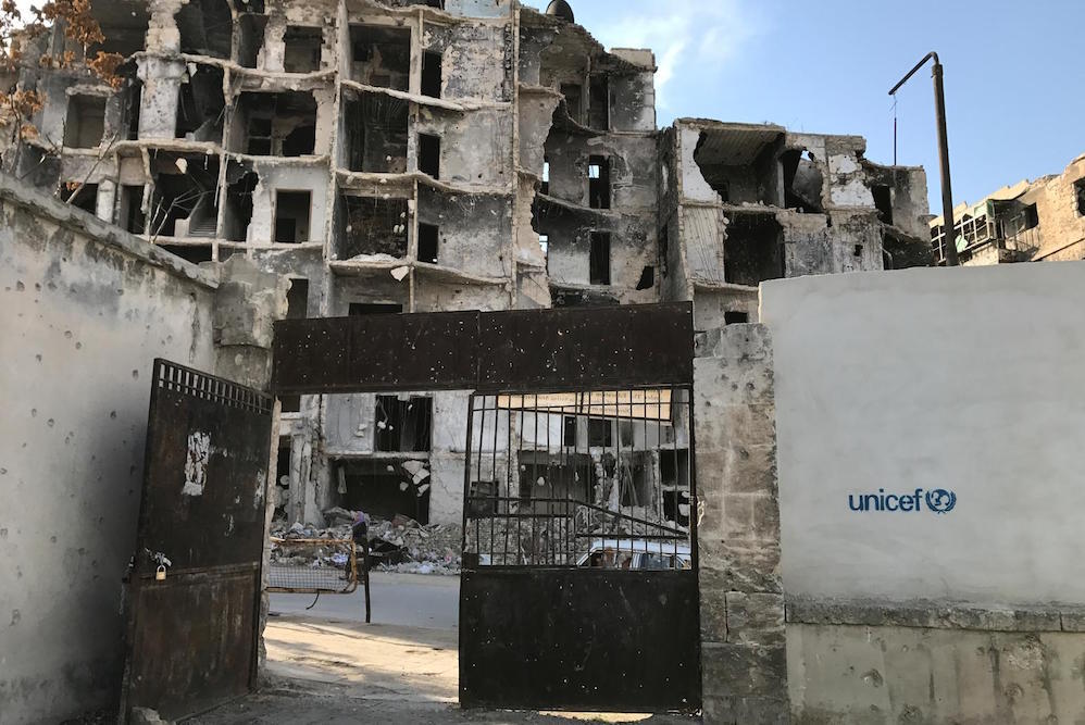 Damaged Buildings Beyond The Gate Of Maysaloon School In Aleppo