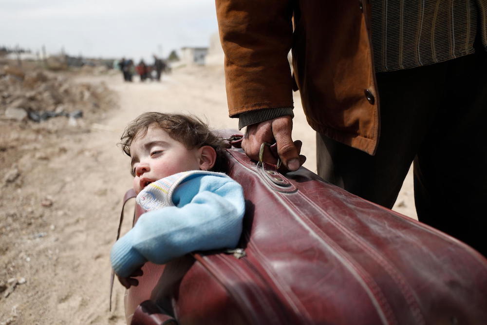 Child Carried In Suitcase As Families Evacuate From Eastern Ghouta