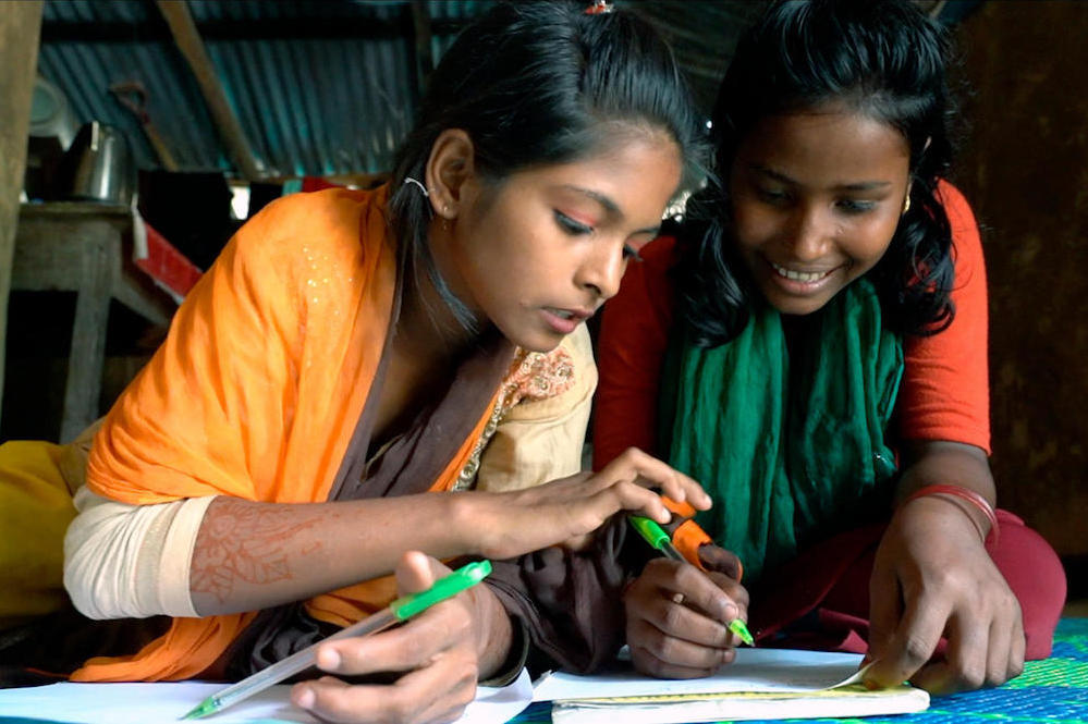 Bangladeshi Student Tasmin Helps Her Rohingya Friend Rajima With Studies At Coxs Bazar Camp