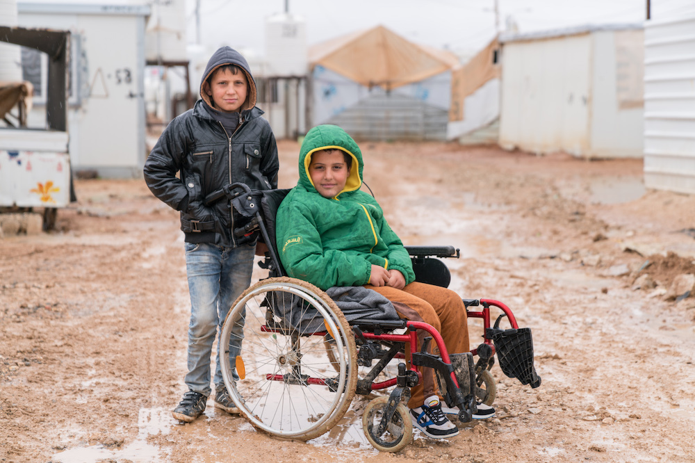 Syrian boy who uses a wheelchair at a refugee camp 