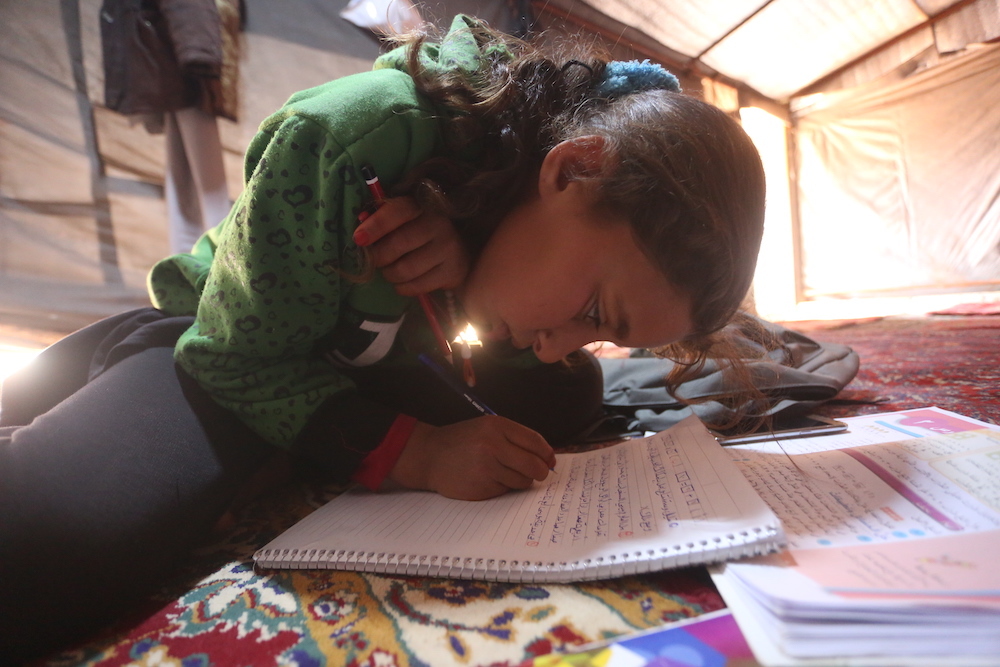 Syrian Girl Does Lesson At Idp Camp