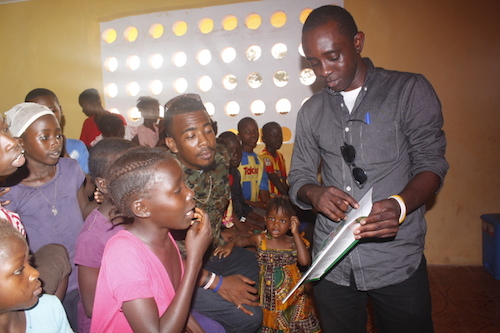 Chernor Bah reads to Ebola orphans in Sierra Leone