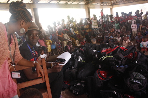 Chernor Bah with schools supplies to distribute to Sierra Leone children