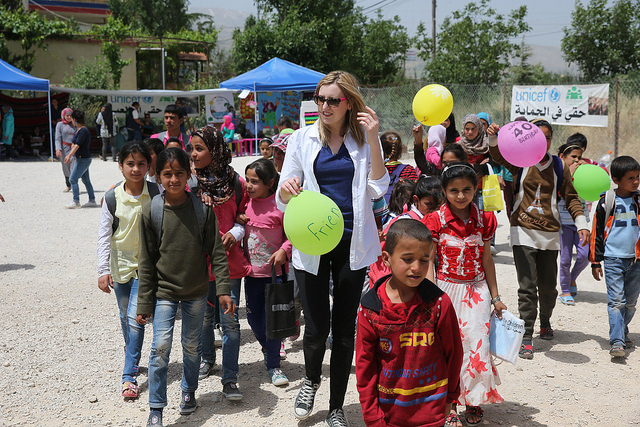 Laura Carmichael with out of school children in Houch El-Oumara tented settlement, Bekaa Vally, Lebanon