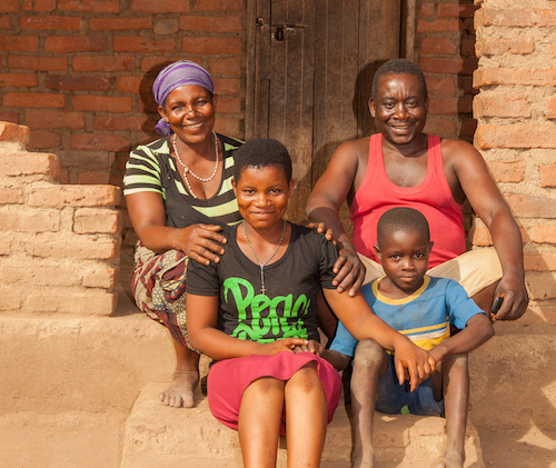 Malawi child marriage - Salome at home with her parents and son Andrew