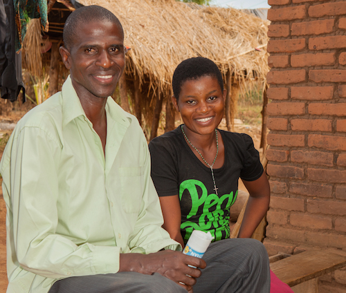 Malawi child marriage - Salome with Benson from her mother and father group picture by Tearfund/Chris Hoskins