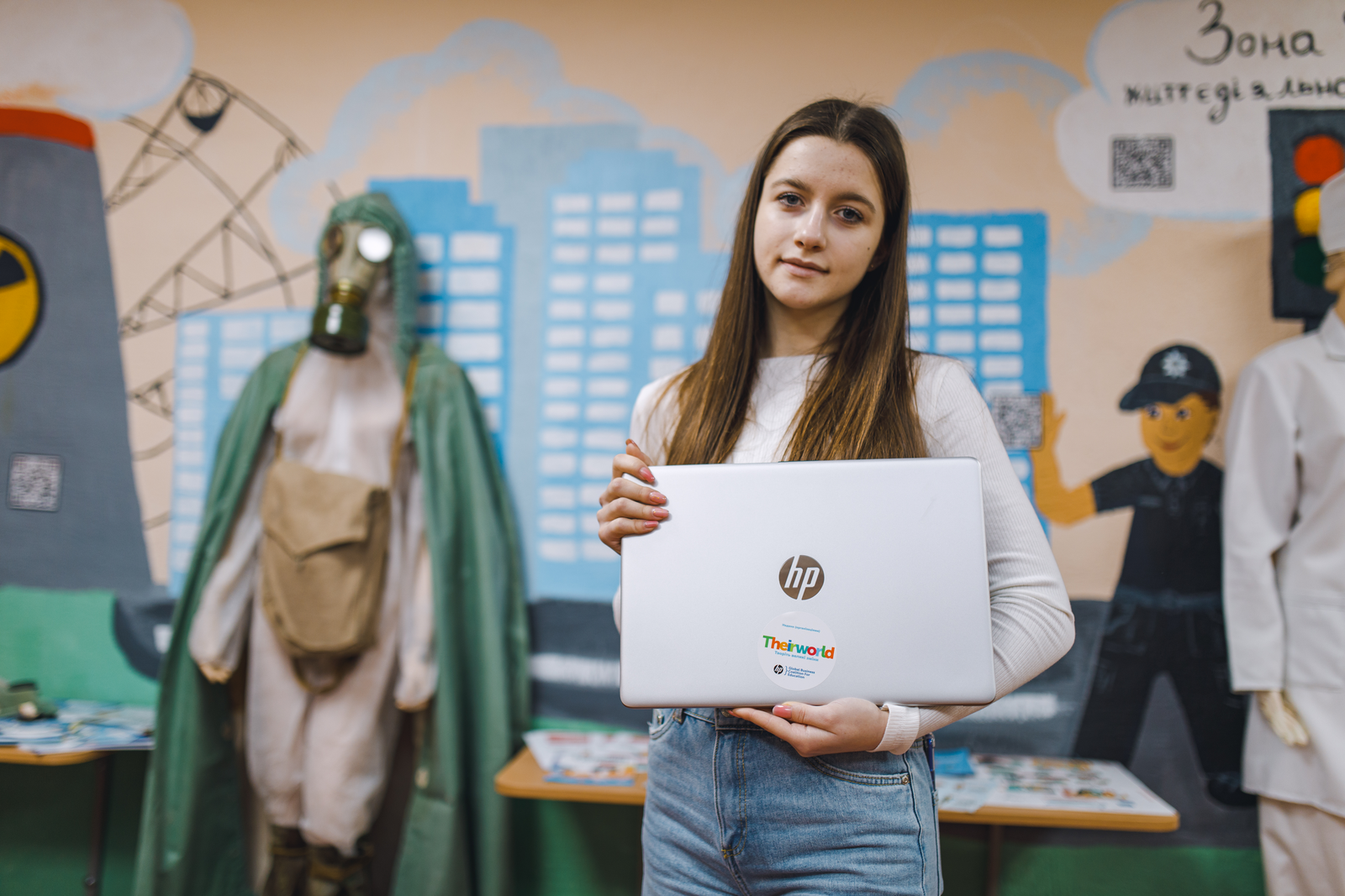 A student in Ukraine holding a Theirworld laptop