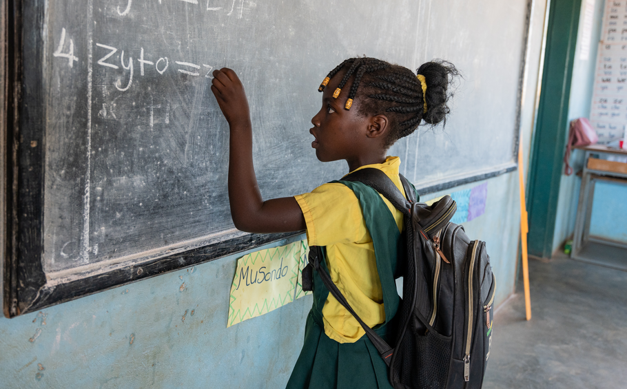 A girl writing on a chalkboard